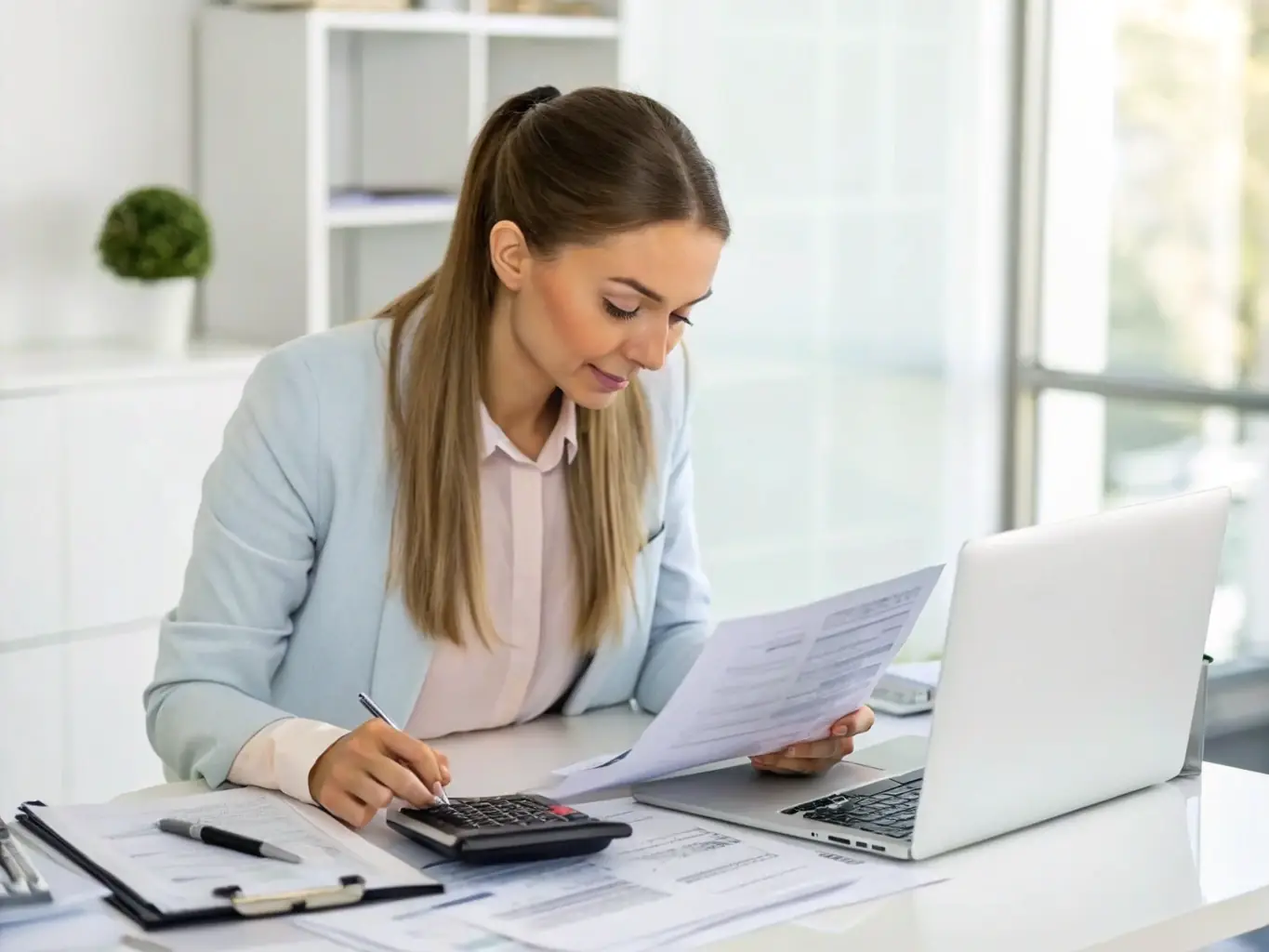 A professional accountant smiling confidently while using VATxpress software on a laptop, showcasing the ease and efficiency of the platform.